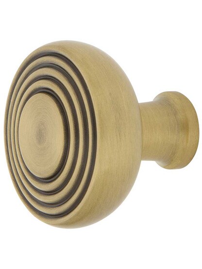 Streamline Deco Cabinet Knob - 1 3/8 inch Diameter in Antique Brass.